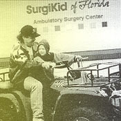 Gene Lasker on 4-wheeler with All Children's SurgiKids patient